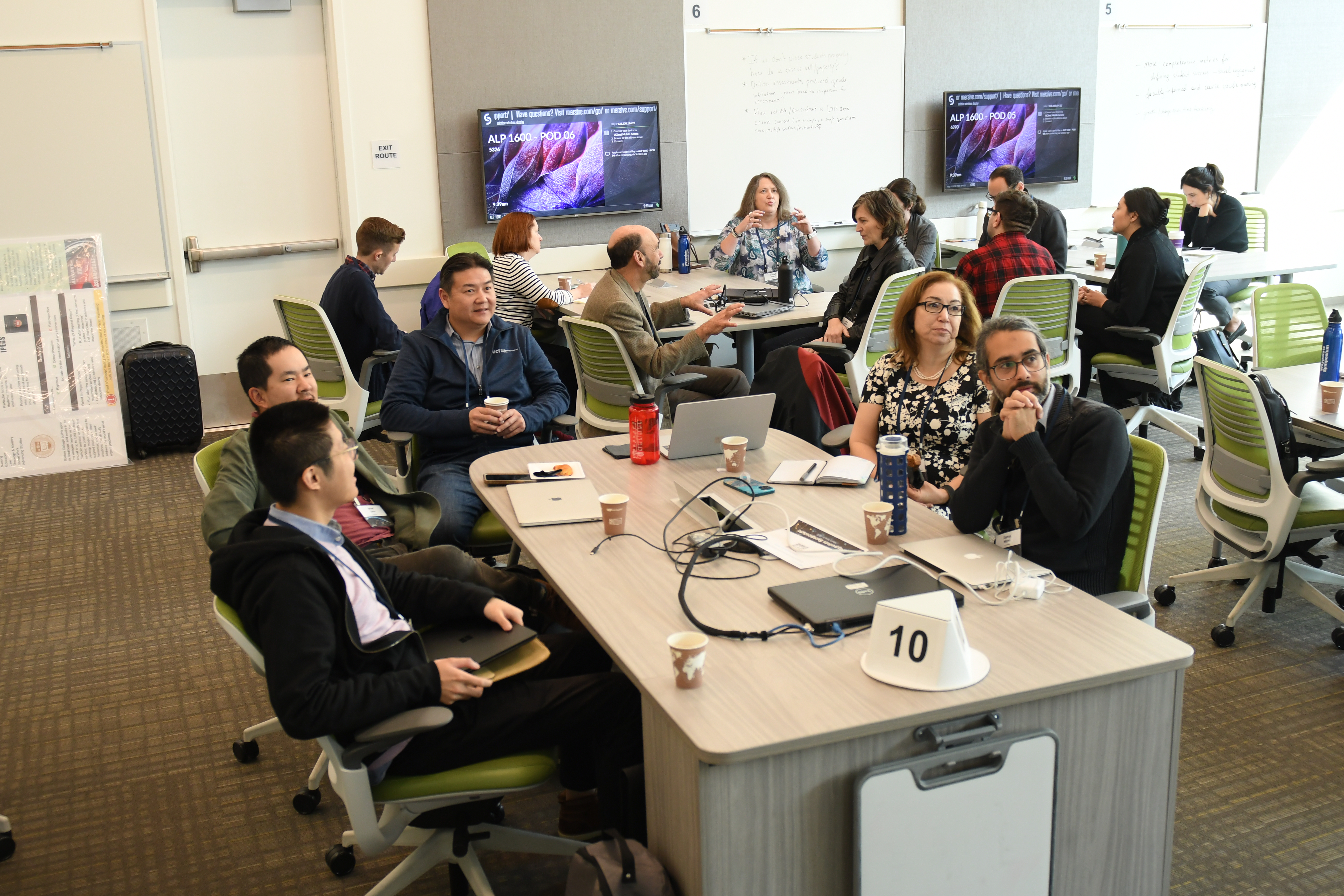 conference participants talking at pods in an active learning classroom